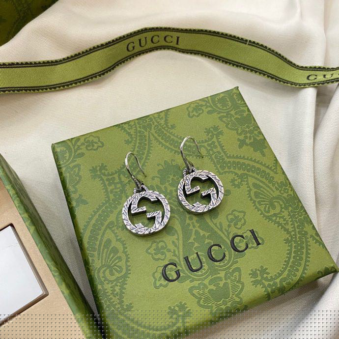 G*u*i earrings